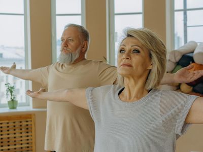 Man stretching his arms in a calm, focused environment.